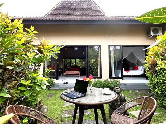 A A Backyard features garden with outdoor furniture and a pavilion dedicated as a private workingspace with a kitchenette at Front Page House, Ambary Ubud Villas