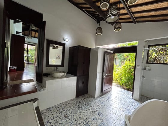 Large bright and airy bathroom with bathtub, shower, big cupboard at the Writers Nest Ambary Ubud Villas